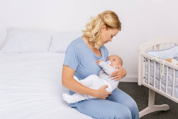 istock mother holding baby 858970174