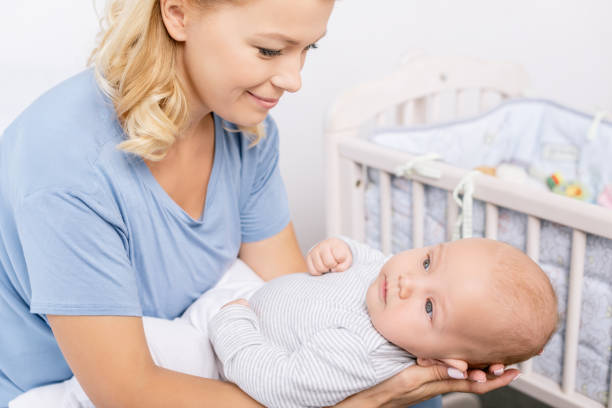 istock mother holding baby 858970994