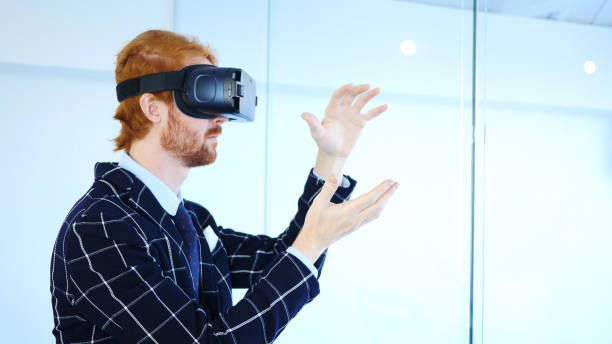 istock Creative Man wearing virtual reality glasses in Office. Using VR goggles headset. 858971170