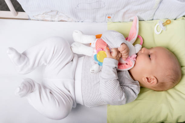 istock baby with toy in crib 858971934
