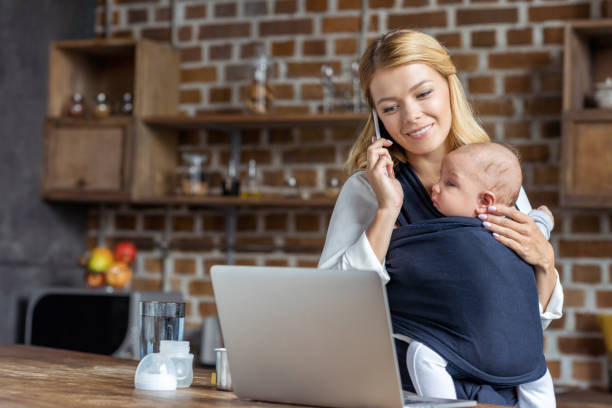 istock businesswoman with baby in hands 858974836
