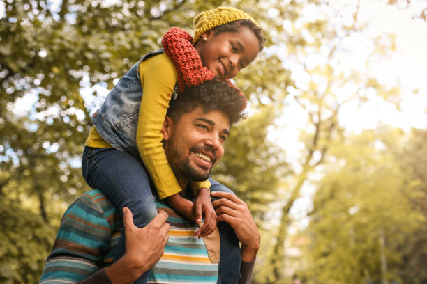 istock African American father with daughter on meadow. 858975000