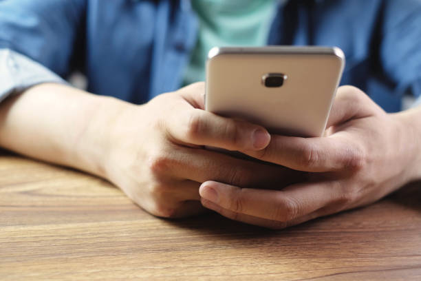 istock closeup business man is working in mobile phone 858975092
