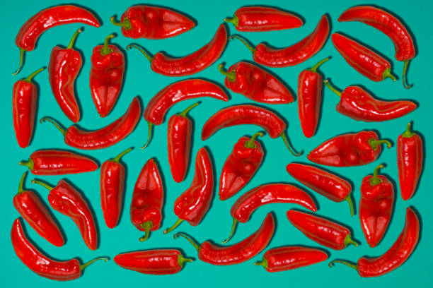 istock Red chili Peppers on green background. 858975550