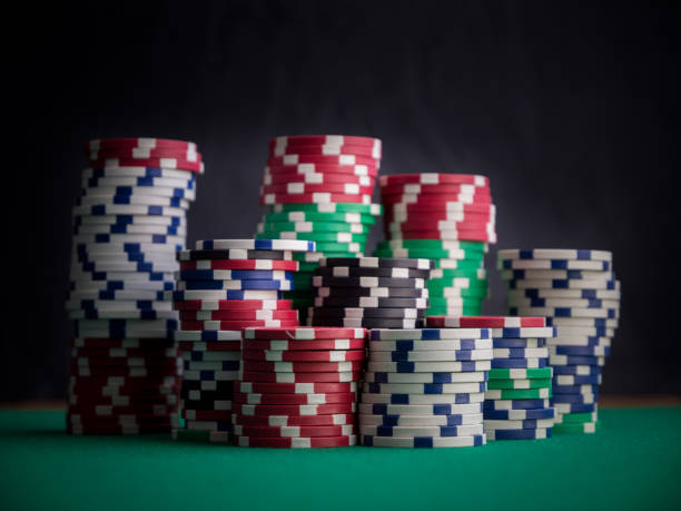 istock stacks of casino chips on green table and black background 858978182