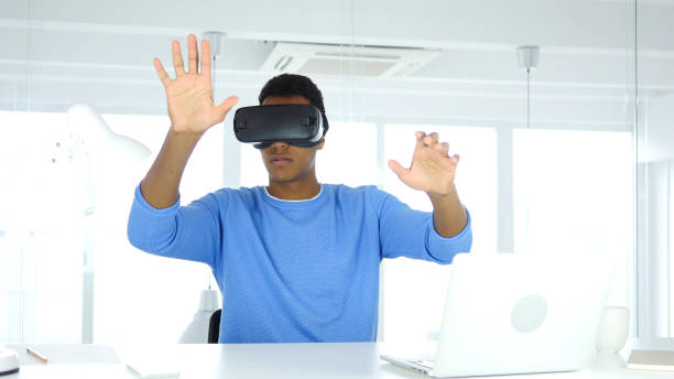 istock Afro-American Man wearing virtual reality glasses in Office, VR Goggles headset 858979430