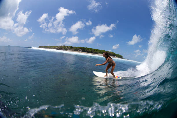 istock Surfer girl on a breaking wave 858986328