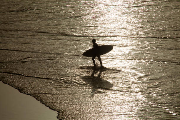 istock Surfer with surfing board walking, seascape. 858987070