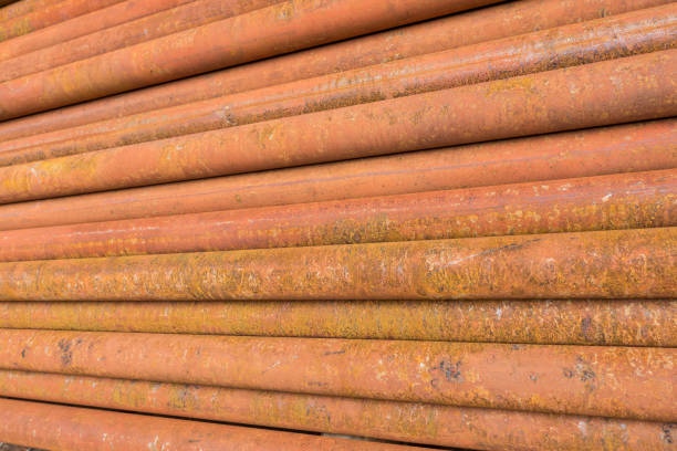 rusty metal tubes and pipes for construction and industrial use laying on heap stock photo