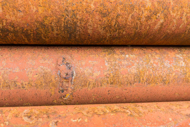point leake on rusty metal tubes and pipes for construction and industrial use laying on heap stock photo