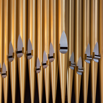 Close up of brass pipes of a pipe organ