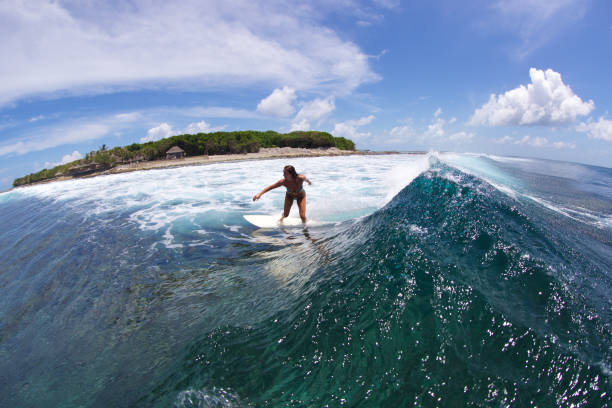istock Girl surfs down the line 858990730