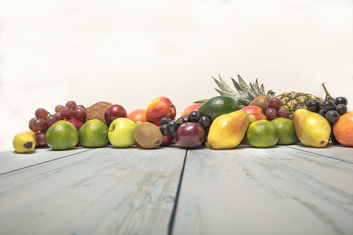 Healthy fruit background ; Studio photo of different fruits on white and  blue  vintage wooden table , high resolution product