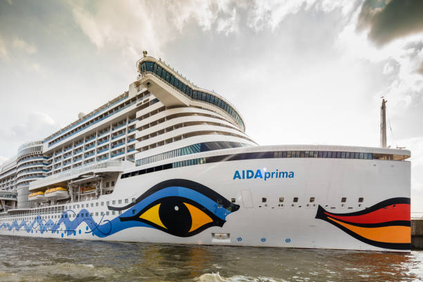 The huge cruise ship Aida prima in Hamburg harbour. This ship was built in 2016 and belongs to the latest ships in the cruise ship line. People on board are waiting for leaving the harbour to head towards the north sea.