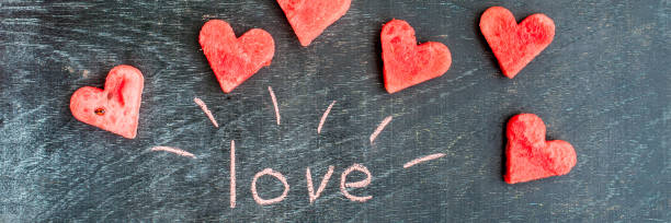 istock BANNER Water melon cut into heart shape. Inscription love with chalk. Flat lay composition. Valentine's Day concept. Long Format 859007910
