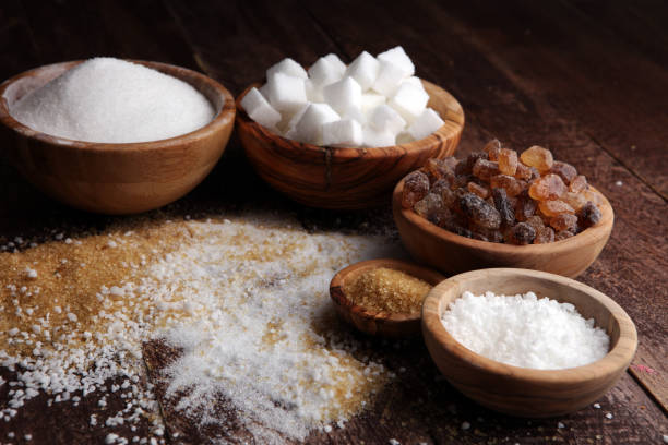 istock Various types of sugar, brown sugar and white on wooden table 859014390