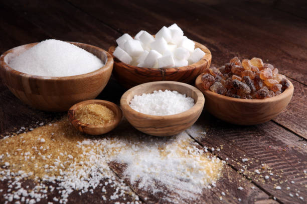 istock Various types of sugar, brown sugar and white on wooden table 859017370