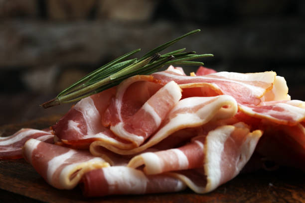 istock Raw sliced bacon with thyme leaves ready for cooking 859017524