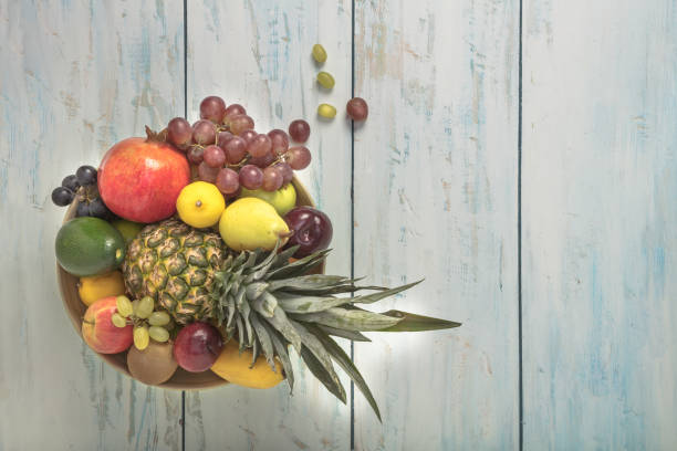 Healthy fruit background ; Studio photo of different fruits on white and  blue  vintage wooden table , high resolution product