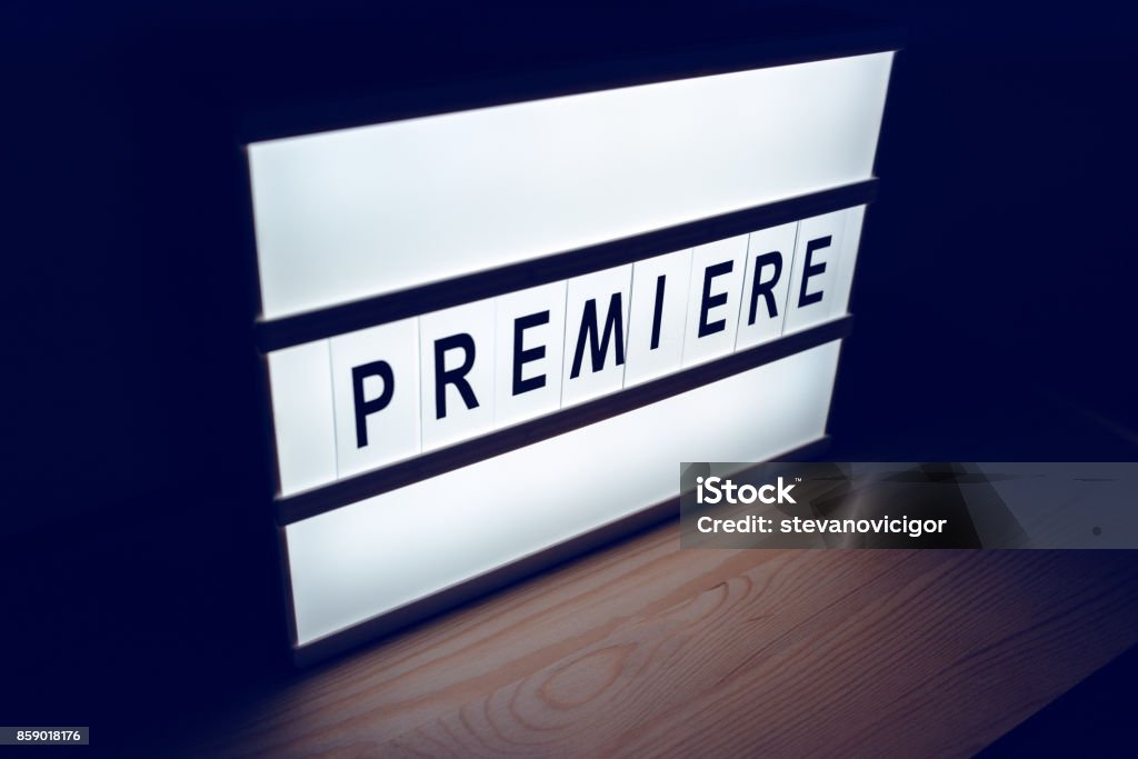 Vintage illuminated lightbox Premiere sign Vintage illuminated lightbox Premiere sign in cinema movie or for radio and television live audience broadcast Announcement Message Stock Photo
