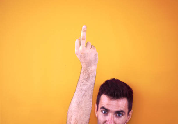 middle finger Attractive man show his middle finger express he is not care. asshole stock pictures, royalty-free photos & images