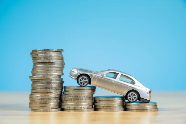 istock miniature car model on stack of coins 859026160