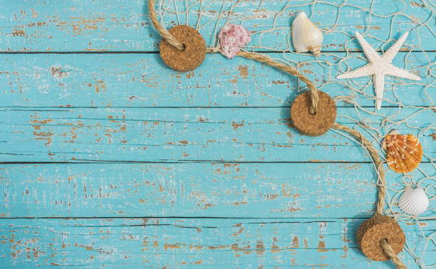 istock Starfish and Seashell in fishing net on light blue plank background 859028638
