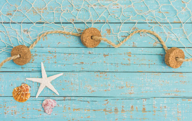 istock Starfish, Seashell and fishing net on light blue plank background 859028698