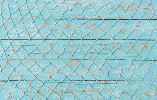 Fishnet decoration on light blue wood.