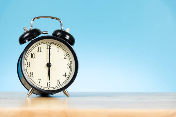 istock alarm clock on the table and blue background 859029226