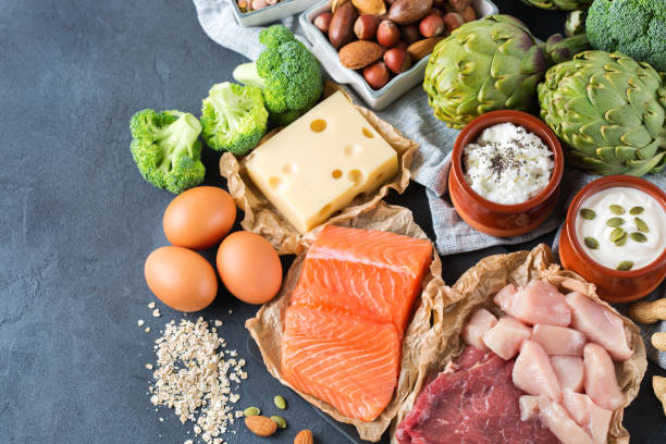 Assortment of healthy protein source and body building food Assortment of healthy protein source and body building food. Meat beef salmon chicken breast eggs dairy products cheese yogurt beans artichokes broccoli nuts oat meal. Top view Artichoke stock pictures, royalty-free photos & images