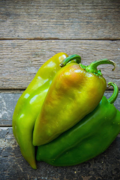 istock Green peppers on wooden board 859040108