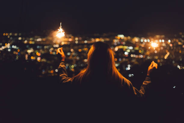istock Girl with sparklers at rooftop terrace 859040270