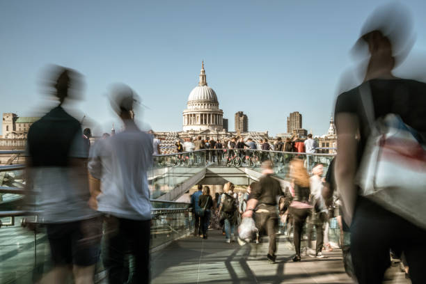 istock Blurred People crossing Millenium Bridge in London, UK 859040278