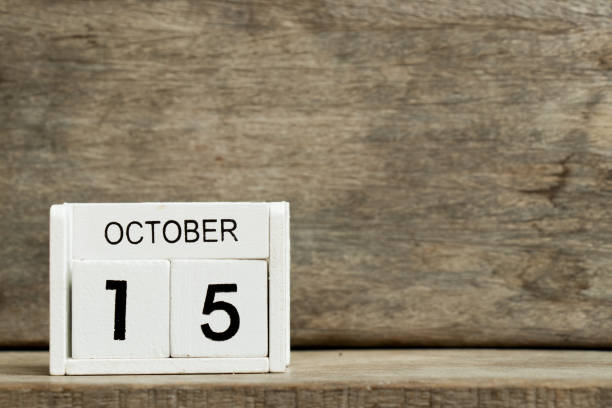 White block calendar present date 15 and month October on wood background (Breast Health, International Day of Rural Women, Pregnancy and Infant Loss Remembrance Day)