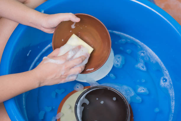 istock women hand using yellow sponge wash the dish 859043432