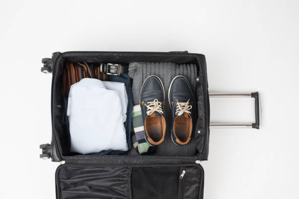 istock Outdoor travel black suitcase with things on a white 859053190