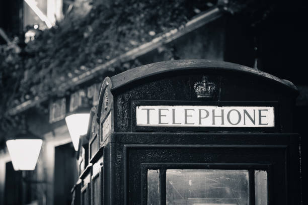Telephone box in street with historical architecture in London in black and white.