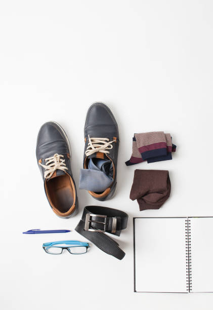 istock Notebook, shoes, belt and socks on white 859058434
