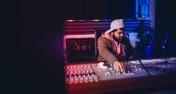 istock Engineer working on sound mixing desk in recording studio 859083960