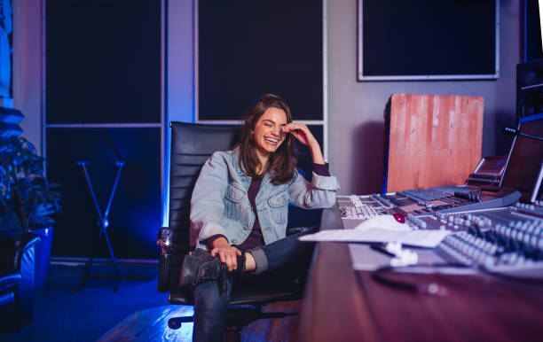 istock Smiling female sound technician in recording studio 859084296