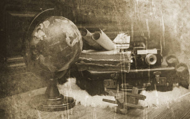 composition on a wooden floor vintage globe with old leather suitcase with objects for travel
