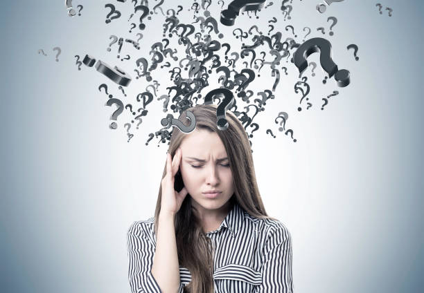 istock Stressed woman in a shirt, question marks 859087748