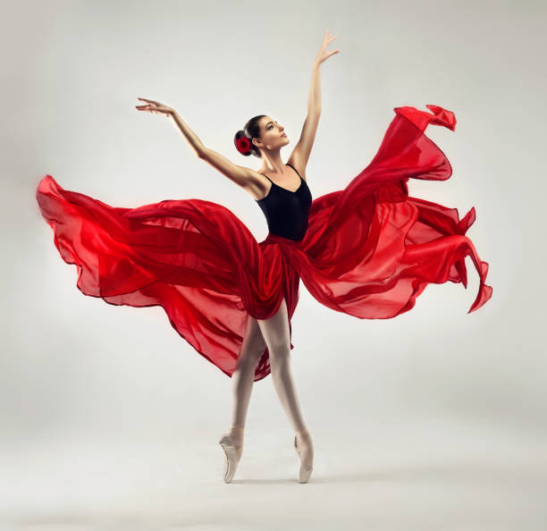 Beauty of classic ballet. Ballerina is performing classic dance. Ballerina. Young graceful woman ballet dancer, dressed in professional outfit, shoes and red weightless skirt is demonstrating dancing skill. Beauty of classic ballet. ballet dancer stock pictures, royalty-free photos & images
