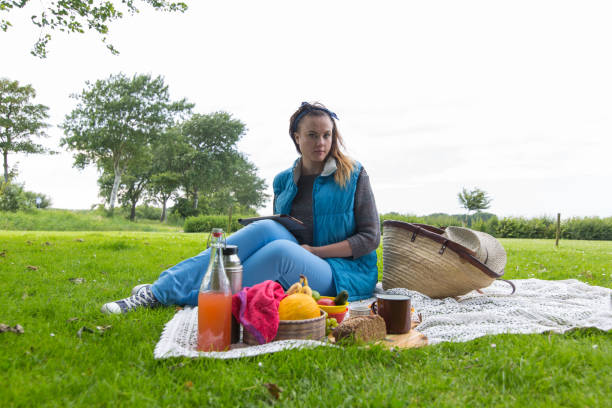 istock Young woman with tablet pc at a picnic 859094656