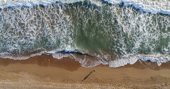 High angle view of man jogging on the beach