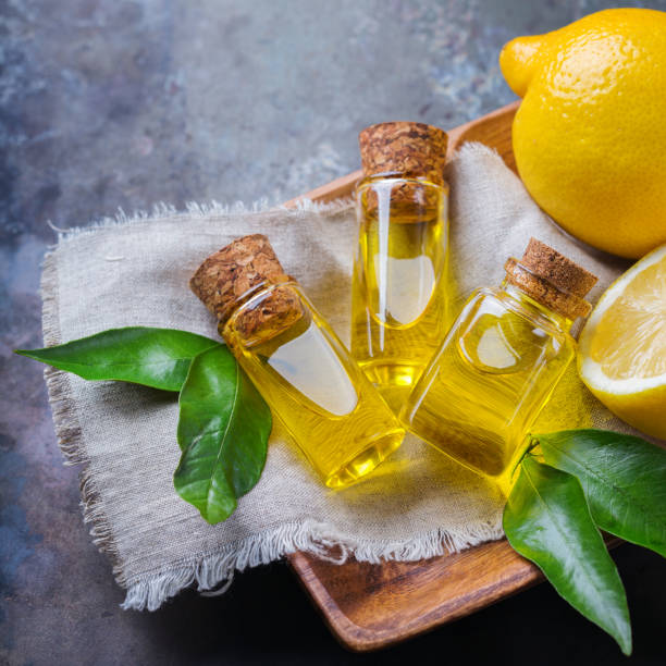 istock Organic essential lemon oil with green leaves and fruit 859111426