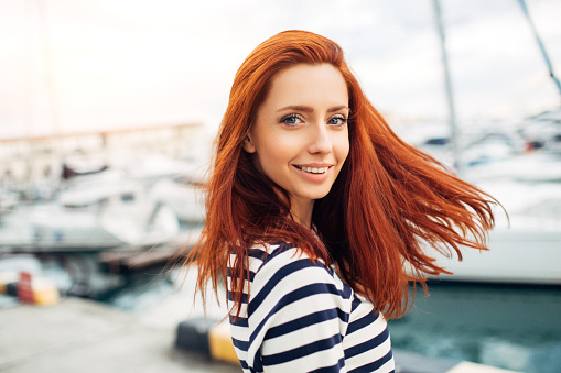 Studio shot of young beautiful woman on a pier