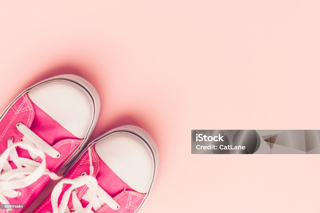 Pink canvas shoes with on pink background Above Stock Photo