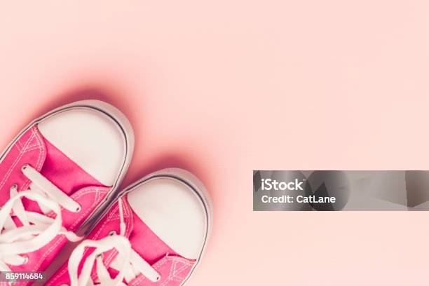 Pink Canvas Shoes With On Pink Background Stock Photo - Download Image Now - Above, Arts Culture and Entertainment, Backgrounds